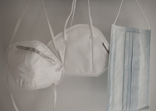 photo of three face masks hanging from a wall