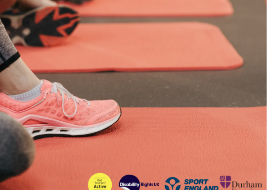 Image of trainers on a yoga mat with the disability rights uk, get yourself active, sport england and durham university logos