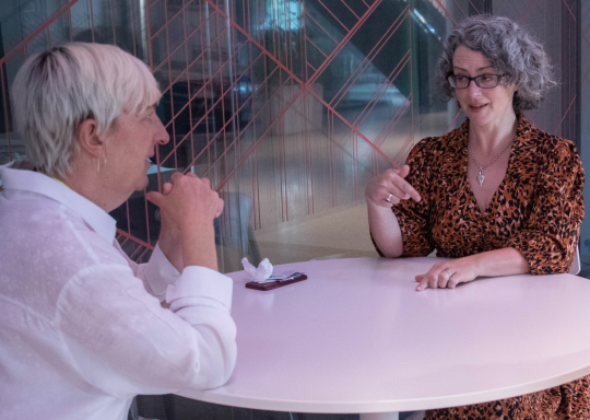 Image of one of our trustees and SLT members talking around a table