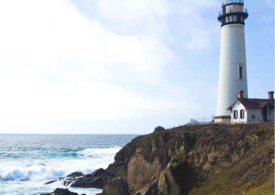 Lighthouse next to the sea on the Cornish coast