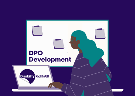 Showing a racialised person working behind a computer with the DR UK logo on screen. Behind them is a white baord with the text 'DPO Development' and three post-it notes
