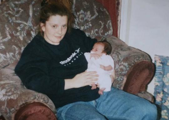 Image of Jodie Whiting as a young mum with a baby on her lap