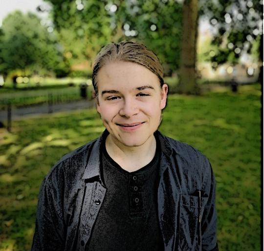 Edward smiling at the camera in a park